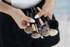 the is holding makeup tools