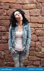 Naughty Mature Woman with Curly Dark Hair and White Shirt and Jeans Jacket  Sticks Out Her Tongue Stock Image - Image of adult, expressions: 208842287