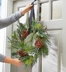 Then loop the string, ribbon, or fishing line over the back of the door, hanging the wreath in front. How To Hang A Christmas Wreath Better Homes Gardens