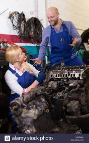 Handsome Happy American Mechanic And Female Assistant