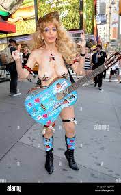 Sandy Kane The naked cowgirl poses with her guitar in Times Square where  she was performing for tips New York City, USA - 12.07.12 Stock Photo -  Alamy
