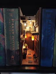 A small table filled with books, pictures, and flowers? 10 Bookshelf Dioramas That Are Basically Works Of Art Popsugar Home