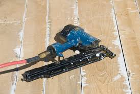 a nail gun to install a hardwood floor