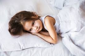 cute little girl sleeping in her bed at