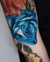 Rip tattoo on a man confers the identity of a caring personality. Blue Rose Tattoos Meanings Tattoo Designs Placement
