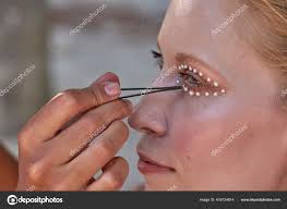 makeup artist working applying pearl