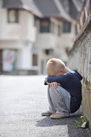 sad lonely boy on street distraught