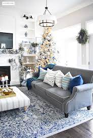 With its diverse range of undertones and ability to pair seamlessly with other hues, this color proves why it is a standout among designers.a rich midnight evokes a more reflective feeling suitable for a home library while a glossy aquamarine exudes just the right amount of energy within a living room. Blue And White Christmas Living Room Citrineliving Blue Living Room Decor Blue And Gold Living Room Silver Living Room