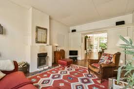 A Living Room With A Red Rug And A