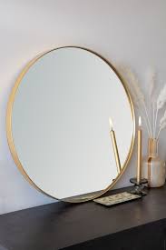 large round gold framed mirror wall