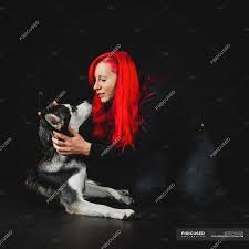 See how this duo hue can be worn in a multitude of ways. Young Woman With Bright Red Hair Playing With Puppy Of Adorable Siberian Husky On Black Background Female Canine Stock Photo 237452502