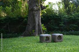 Stone Chairs On Green Grass In Park Or