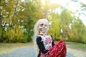cheerleader costume and halfface makeup