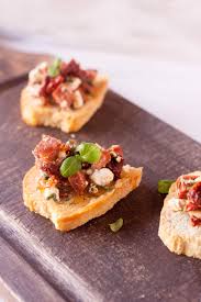 Spread goat cheese over toasts; Spicy Sausage Sun Dried Tomato And Goat Cheese Crostini I Just Make Sandwiches