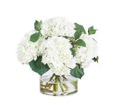 faux white hydrangeas in glass vase