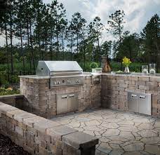 Outdoor kitchens → faux stone outdoor kitchen. The Sleek Look Of The Stainless Steel Pairs Nicely With The Stone Like Blocks And The Natural Outdoor Kitchen Design Diy Outdoor Kitchen Outdoor Kitchen Plans
