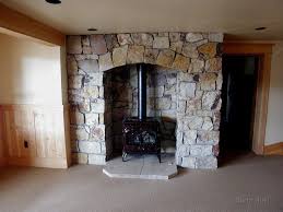 We display and sell a wide variety of hot tubs, fireplaces, stoves, saunas, steam generators, and jacuzzi® whirlpool, air, and soaking bathtubs. Wood Stove With Flagstone Fireplace Surround Fireplace Wood Burning Stove Basement Fireplace