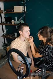 young woman and man making a makeup