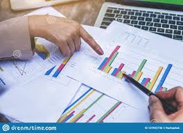 Two Business Women Review And Analyzing Income Charts And