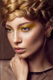 gold dress with creative makeup