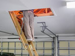 man inspecting garage attic male