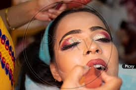 image of an indian woman getting makeup