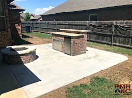 new concrete patio with fire pit and