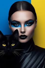 a woman with a black cat on her face