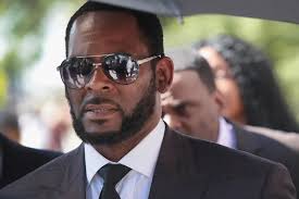 R Kelly Charged With Sex Crimes After Paying 17 Year Old