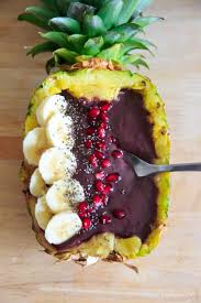 pineapple acai smoothie bowl or boat lots of tropical fruit vibes and a handful of