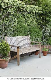 Make the most of the sunnier days with our beautiful range of garden furniture. Wooden Garden Bench Traditional Wooden Garden Bench On A Patio In An English Garden Canstock