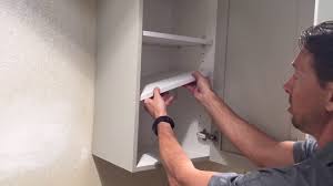 remove a shelf from a kitchen cabinet