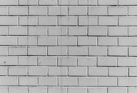 A Black And White Photo Of A Brick Wall