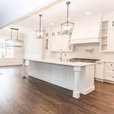 Large White Kitchen With Lantern Style Chandeliers Pendants Kitchen Island Lighting Kitchen Layout Modern Kitchen Island