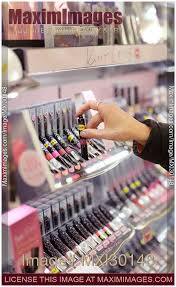 woman taking lip gloss lipstick tester