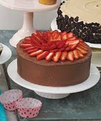 In a large bowl, beat butter, eggs and vanilla. Yellow Cake With Strawberry Filling And Chocolate Sour Cream Frosting Recipe Real Simple