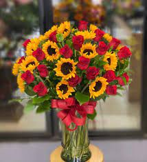 Take one look at a gathering of sunflowers and it's not hard to see why these flowers attract so much attention. Captivating Sunflower And Rose Bouquet In Grand Prairie Tx Vivid Flowers
