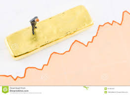 Businessman Standing On The Price Chart With Gold Bar Stock