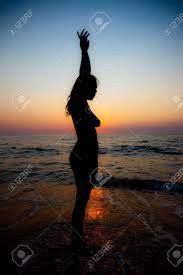 Nude Woman Silhouette At Sunset On The Beach Stock Photo, Picture and  Royalty Free Image. Image 13358150.