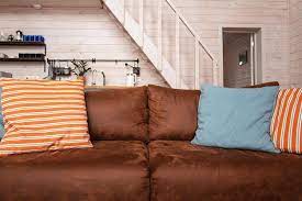 Old Brown Leather Couch In Wooden House