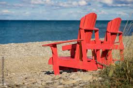 Red Muskoka Chairs On The Banks Of The