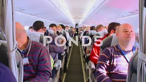 interior of airplane with pengers on