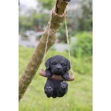 black labrador puppy hanging