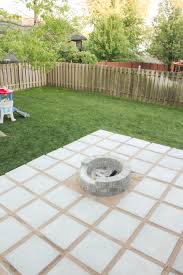 diy patio with grass between pavers and