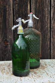 Green Glass Bottle In Rusty Metal