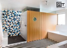 Full bathroom remodel with gray herringbone floor tile, white subway tile walls, black vanity and pops of bright colors. Designers Share Their Tips For Pairing Floor Tiles With Wall Tiles In Bathrooms Granada Tile Cement Tile Blog Tile Ideas Tips And More