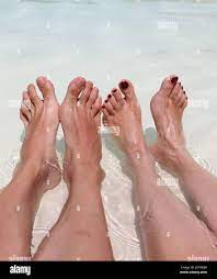 feet of husband and wife on their honeymoon relaxing in the swimming pool  of the Resort Stock Photo - Alamy
