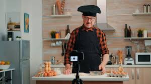 Cheerful elderly baker man filming cooking vlog in home kitchen. Retired  blogger chef influencer using internet technology communicating, shooting  blogging on social media with digital equipment Stock Video Footage -  Storyblocks