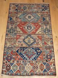 antique caucasian kazak rug with faded