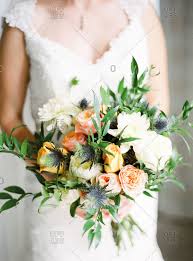 Maybe you would like to learn more about one of these? Bride Holding Wedding Bouquet Of Yellow Pink And White Flowers Stock Photo Offset